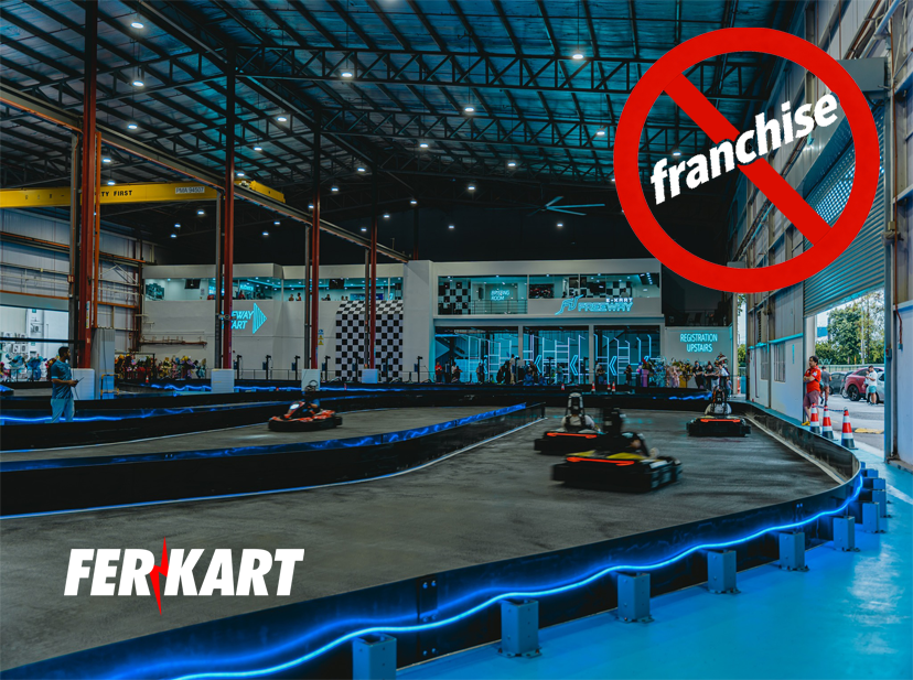 Indoor go kart track with LED barriers and drivers racing — representing independent kart track builders without franchise fees by Ferkart